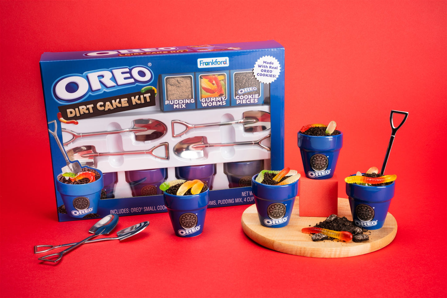 OREO Dirt Cake Kit with blue pots, pudding cups, and cake pieces on a red background