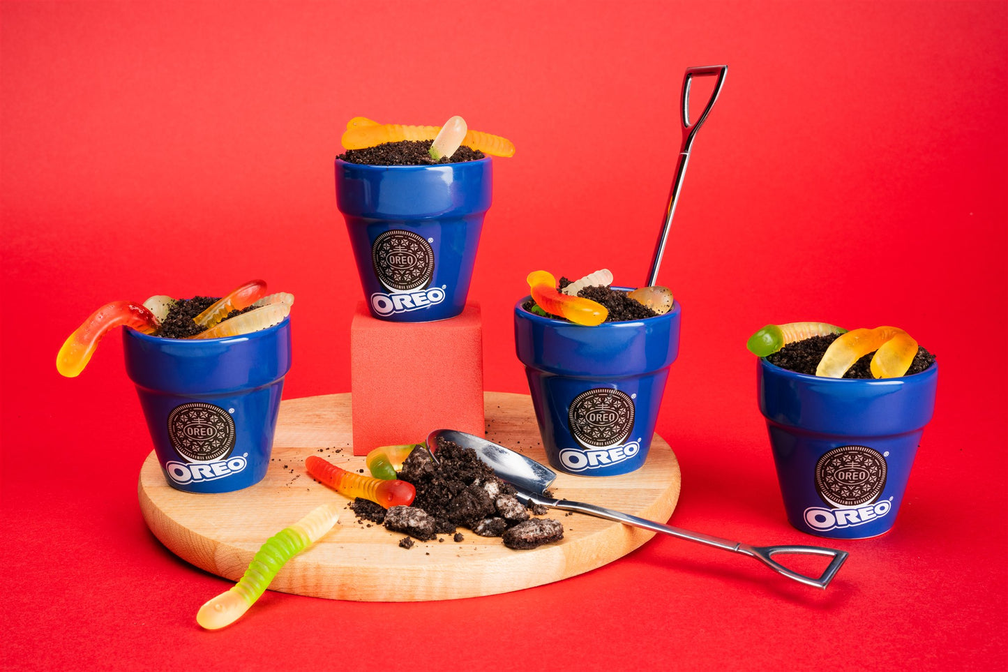 OREO cookie pots with gummy worms on a red background