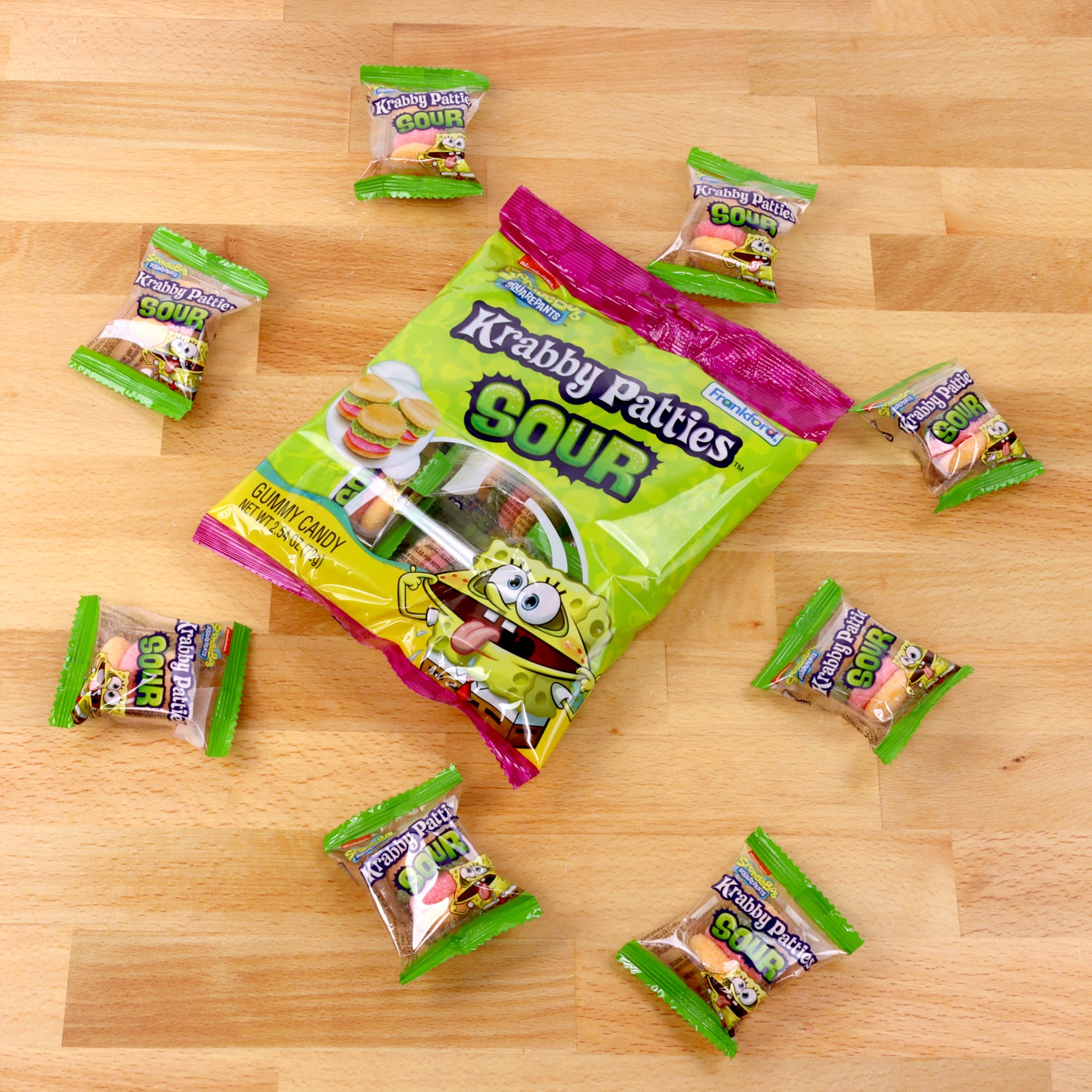sour krabby patties bag surrounded by individually wrapped sour krabby patties