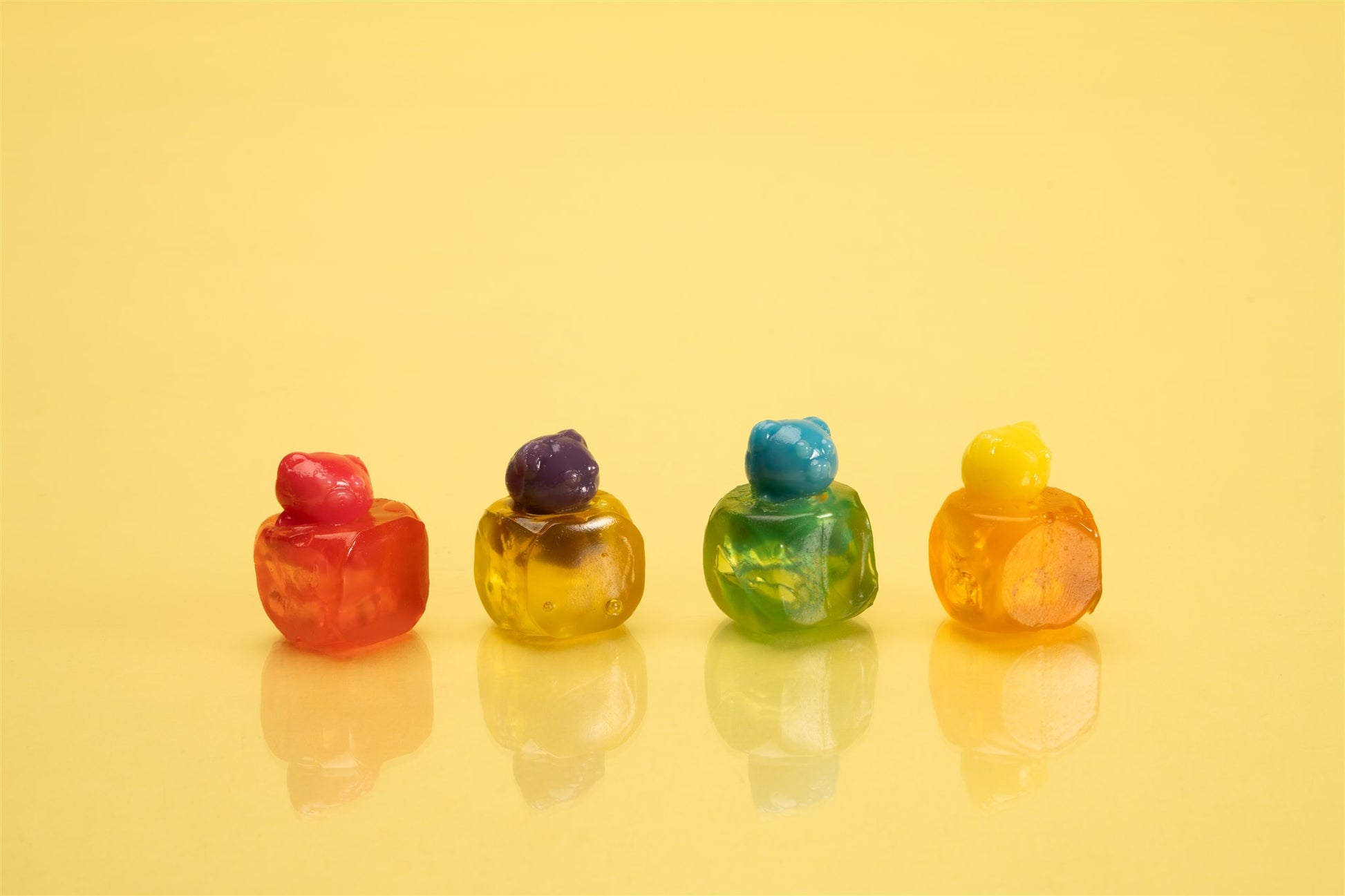 gummy animals peeking out of gummy cubes to show how the candy peels and reveals