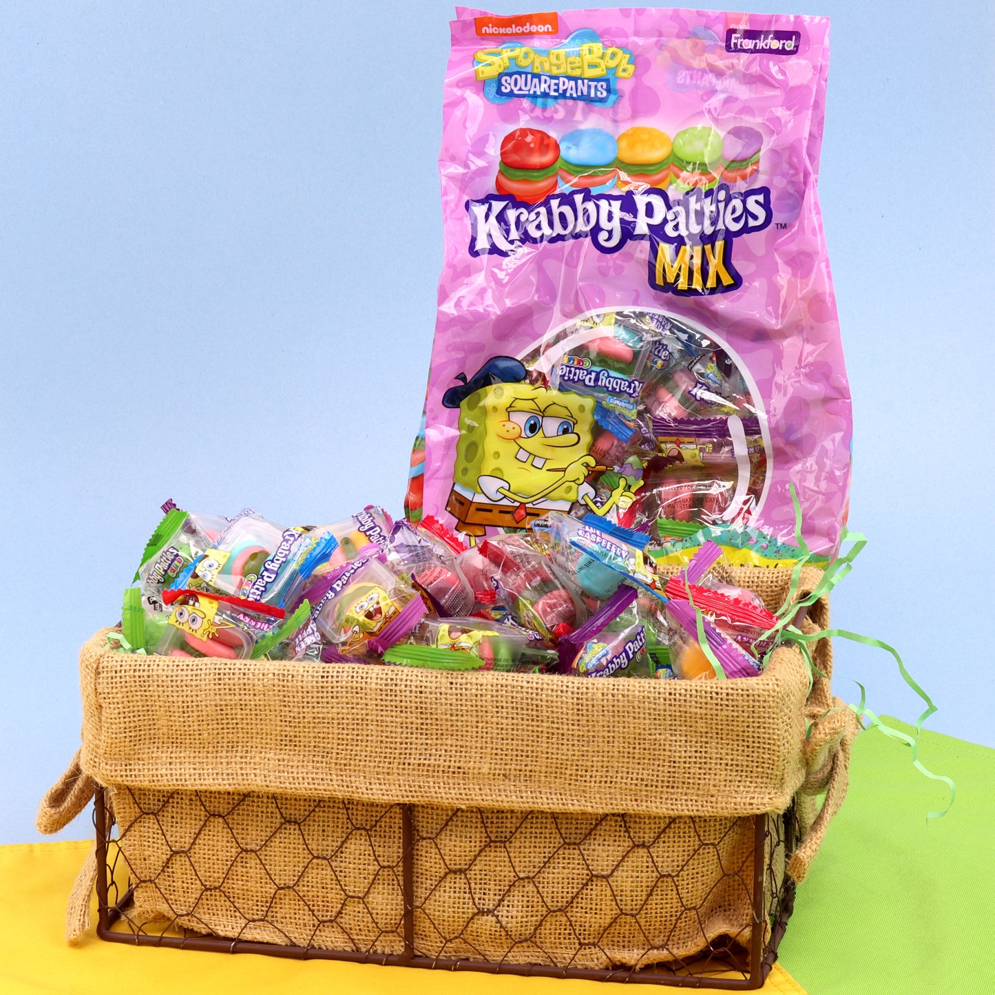 pink and yellow bag filled with colorful krabby patties and a basket full of krabby patties