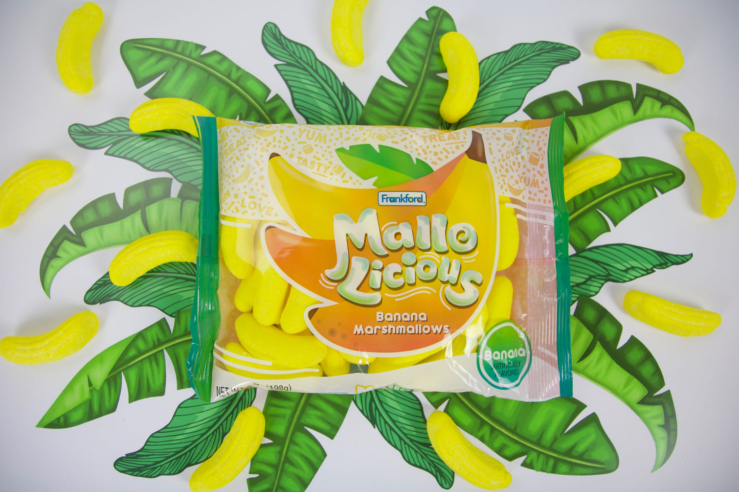 Mallo Licious Banana Marshmallow package and candy over banana leaves illustration