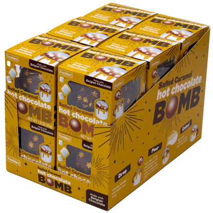 angle of yellow display with 6 individual yellow boxes each with 1 brown and snow flake print foil wrapped hot chocolate bomb