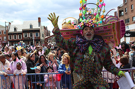 a man dressed up for halloween in a colorful costume covered in easter eggs