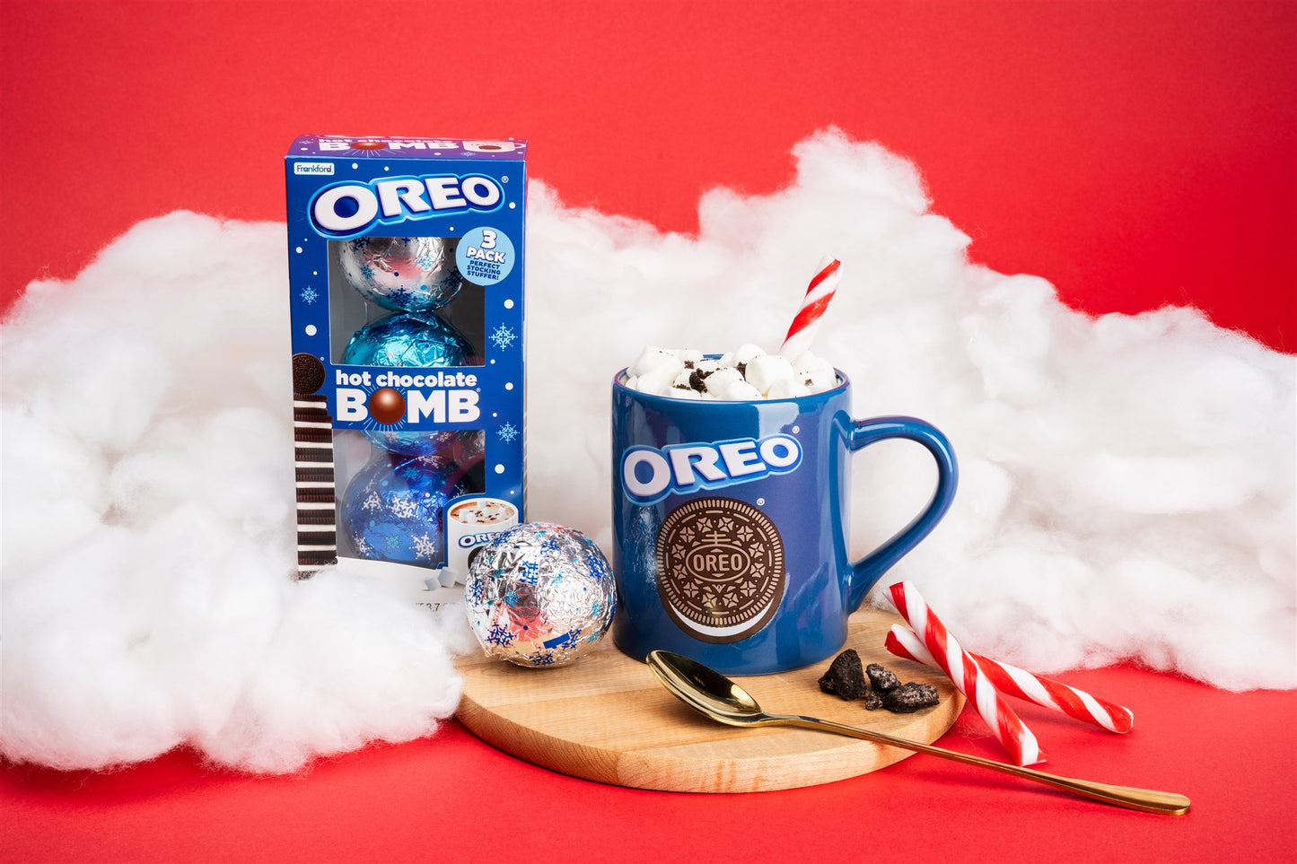 3 pack bomb and mug infront of clouds and red background