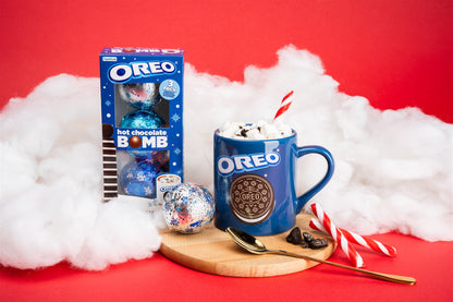 3 pack bomb and mug infront of clouds and red background