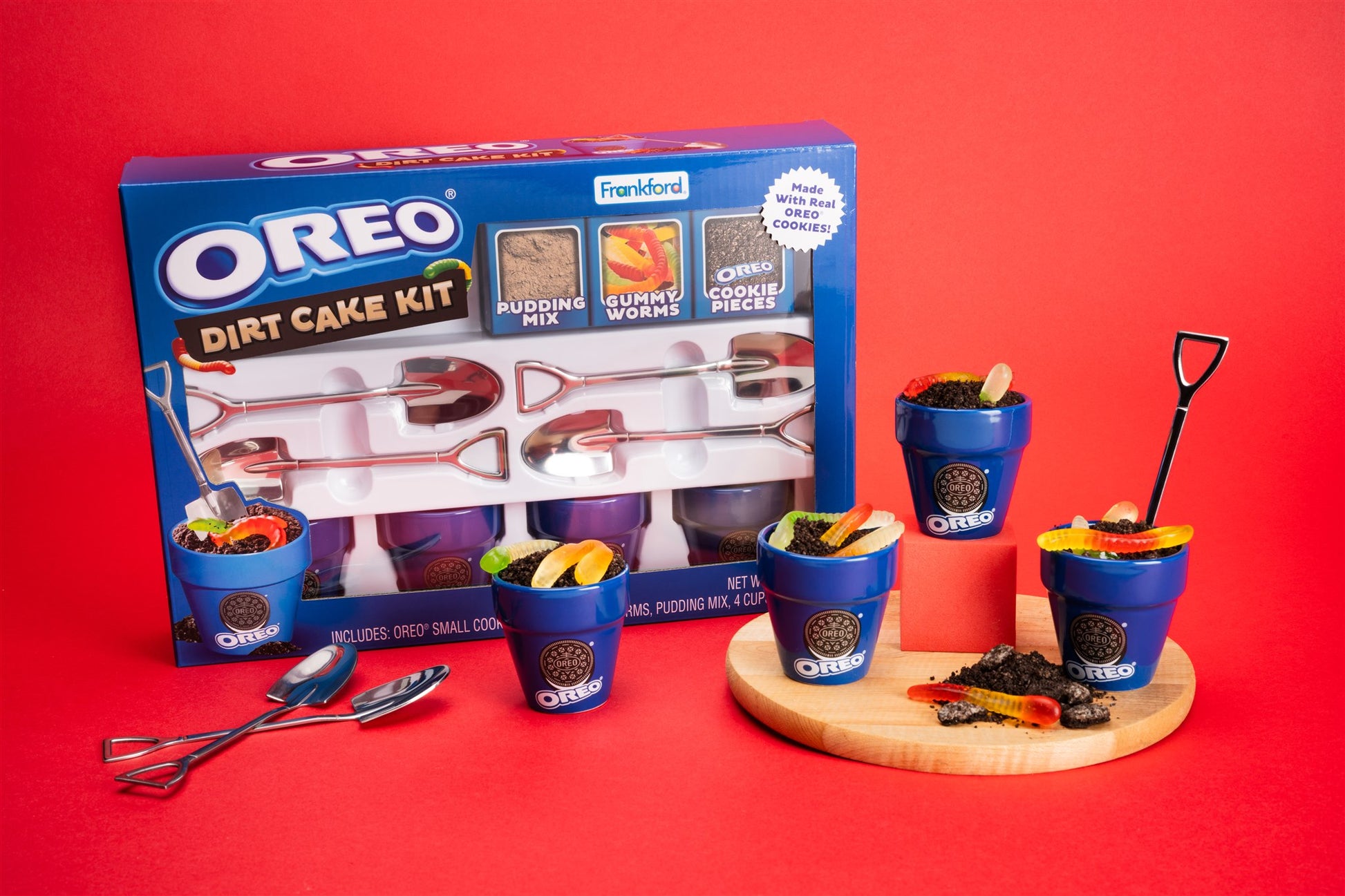 OREO Dirt Cake Kit with blue pots, pudding cups, and cake pieces on a red background