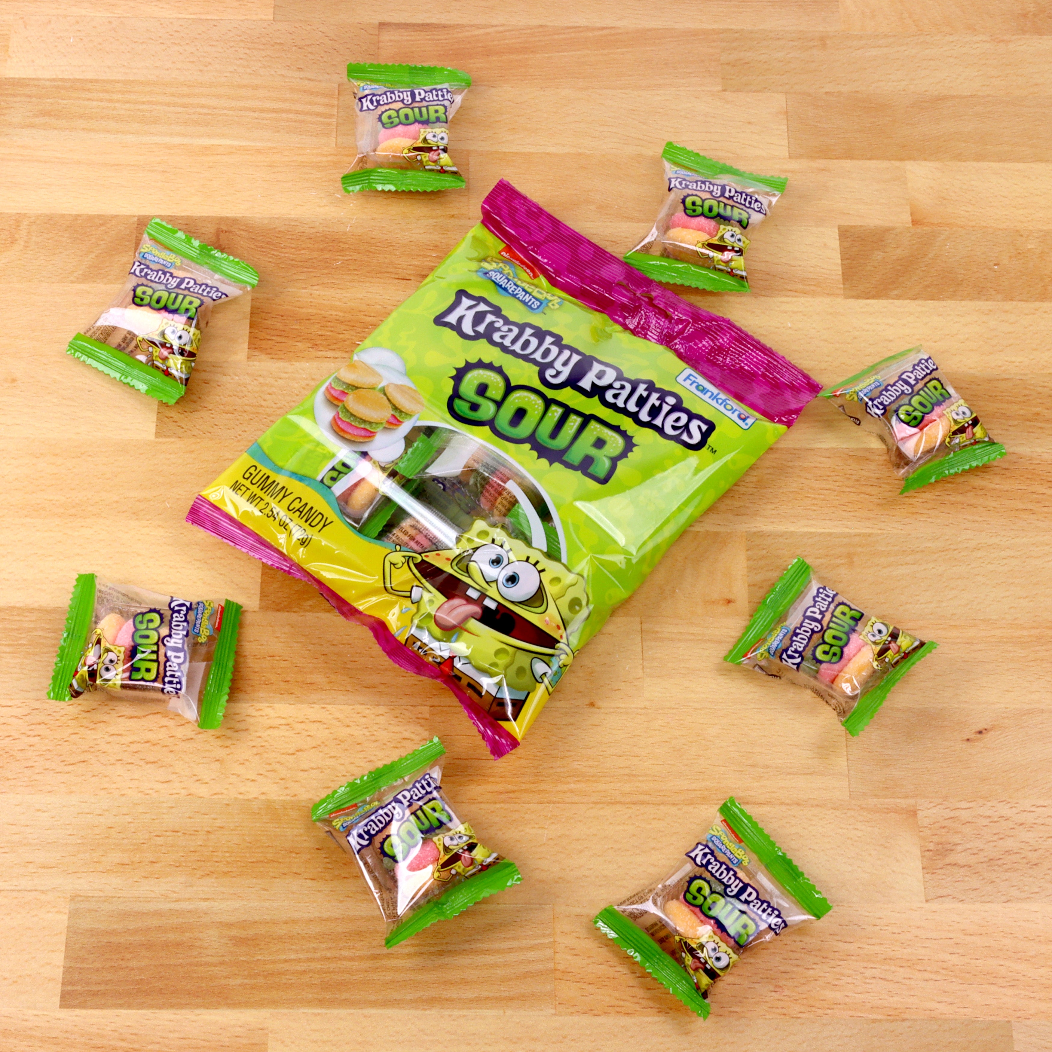 sour krabby patties bag surrounded by individually wrapped sour krabby patties