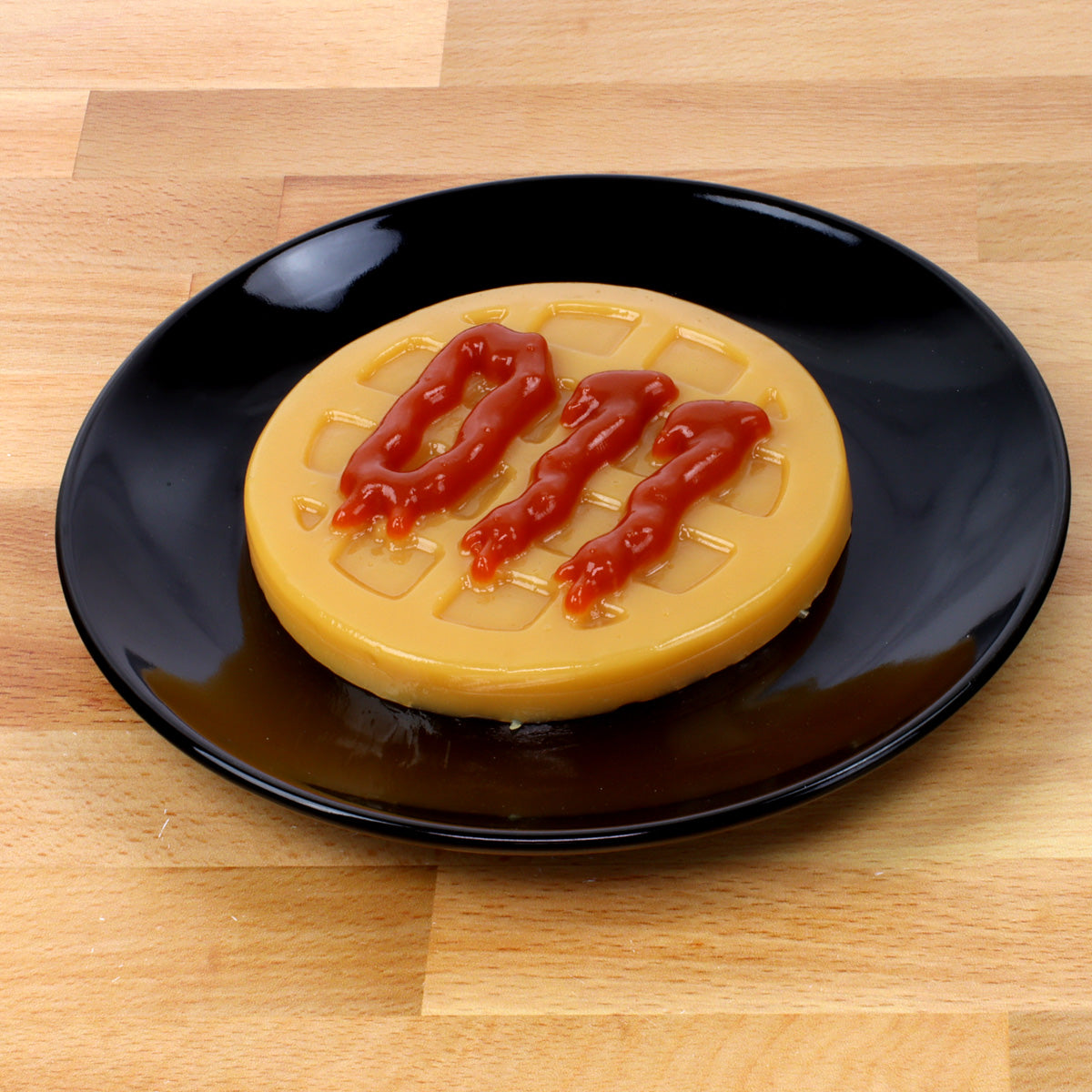 Stranger Things gummy waffle on a black plate on a wooden surface