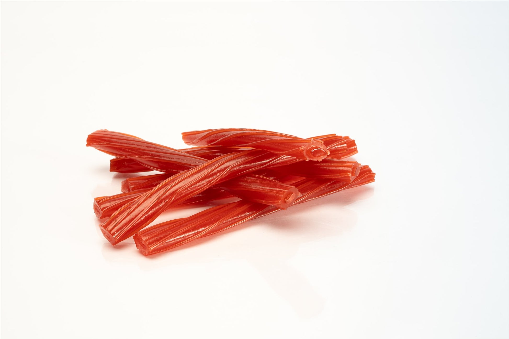 Red licorice sticks on a white background