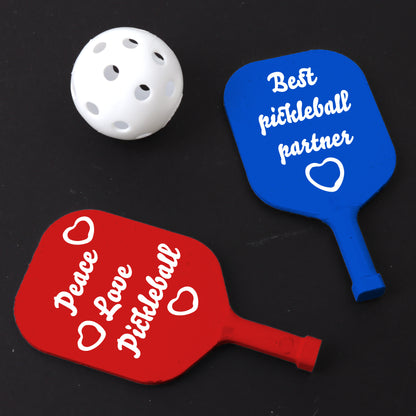 a red and a blue pickleball paddle and a white ball