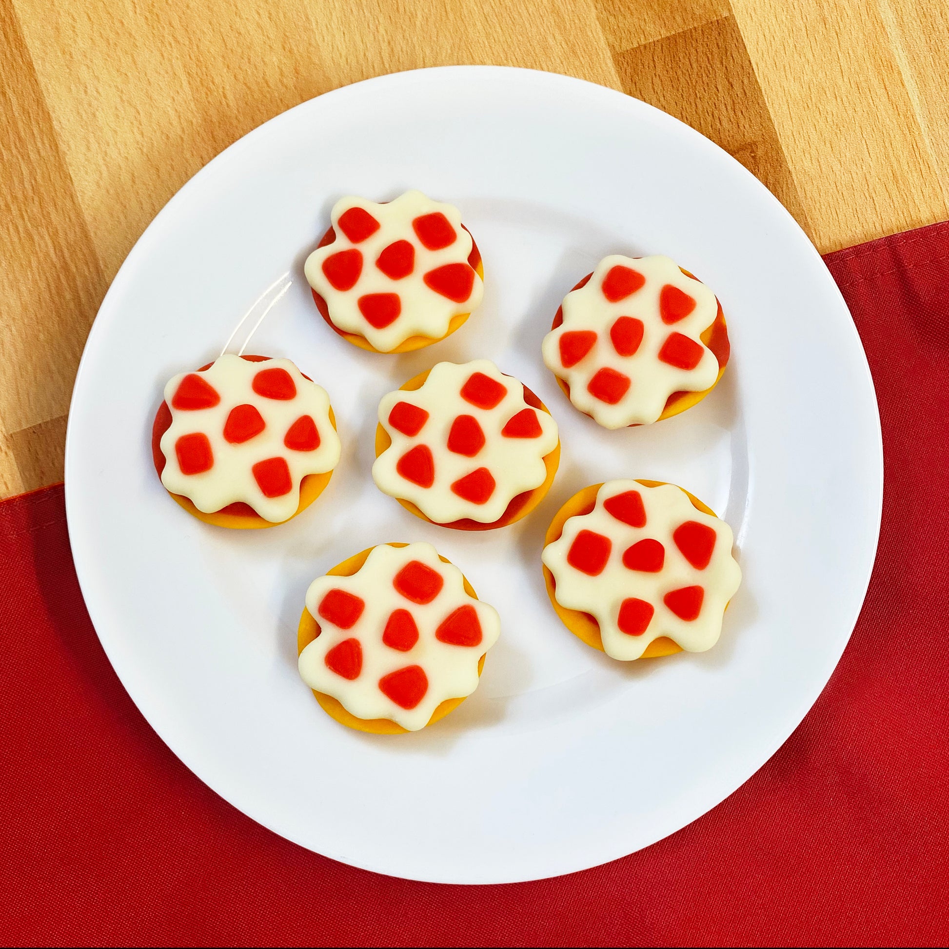 bagel bites shaped gummy candy on a white plate
