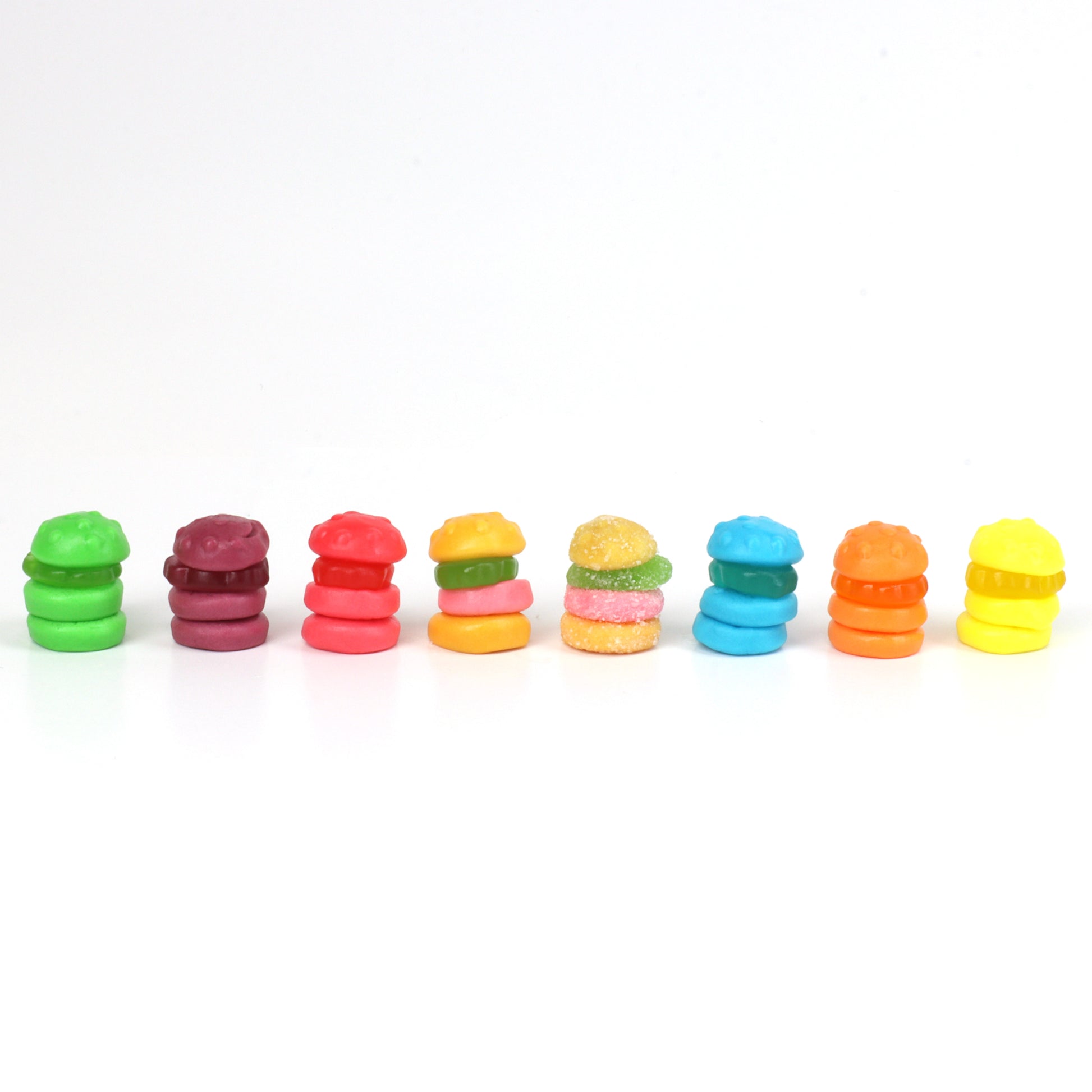 Row of colorful krabby patties on a white background