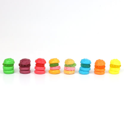 Row of colorful krabby patties on a white background