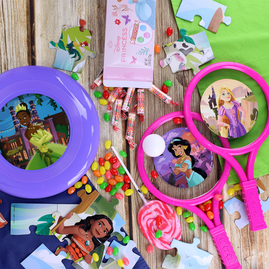 Contents of Disney Princess Easter Basket laid out on a wood table 