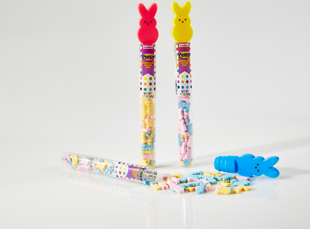 one pink bunny tube topper and one yellow bunny tube toppers standing and filled with colorful hard candies and opened blue bunny tube topper laying down