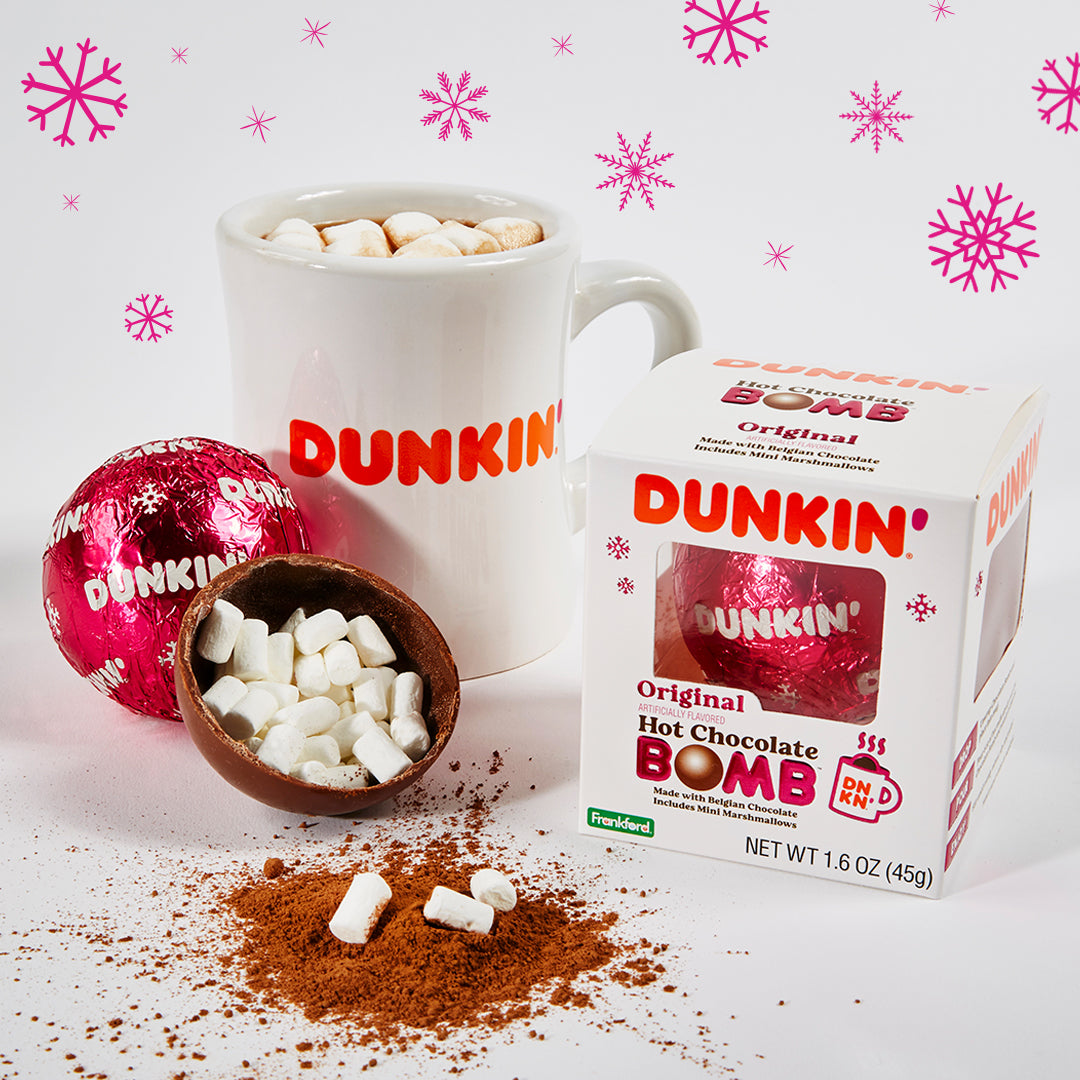 white Dunkin' mug with hot chocolate and mini marshmallows, opened hot chocolate bomb with mini marshmallows, pink foil wrapped with dunkin' logo bomb, and dunkin' original hot chocolate bomb box
