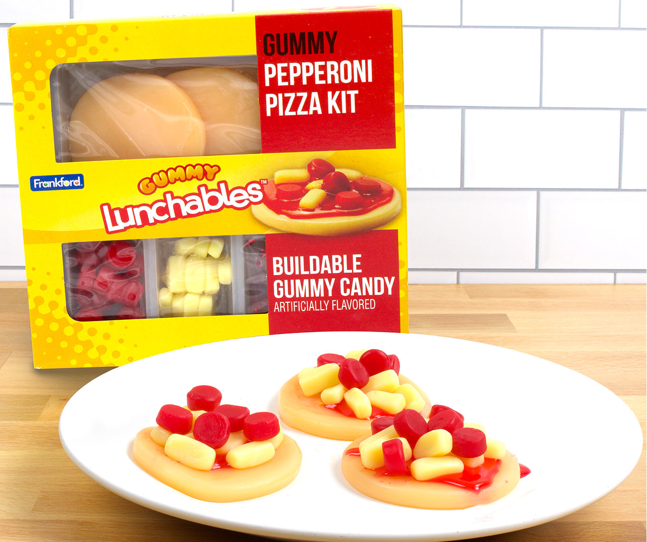 Yellow lunchables box with plate of round gummy pizzas