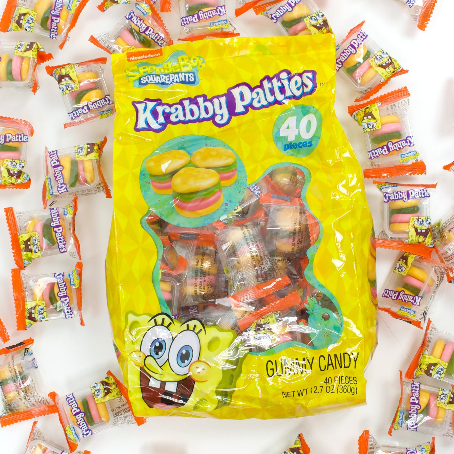 yellow bag surrounded by individually wrapped krabby patties burgers gummies
