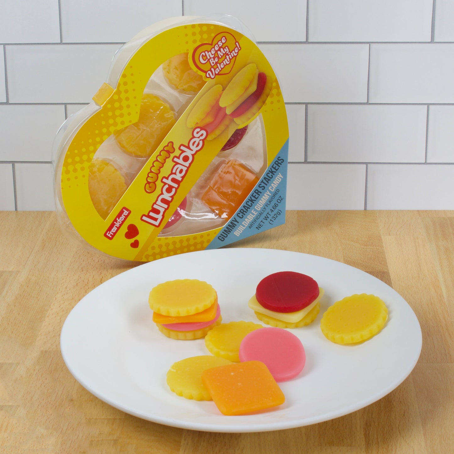 Yellow heart shaped box on its side with plate of gummy cracker stacks