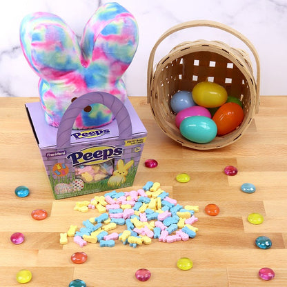Purple Basket and tie dye plush gift set surrounded by colorful bunny candies and straw basket with plastic eggs