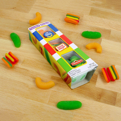 White gummy candy box at angle surrounded by opened mac and cheese, pickle, and hot dog gummies