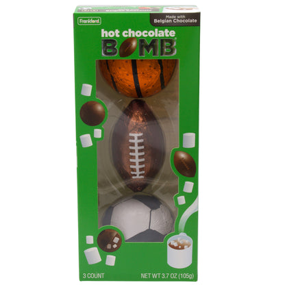 green box with three foil wrapped hot chocolate bombs shaped and decorated like a basketball, football, and soccer ball