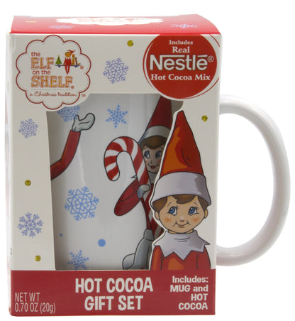 White Christmas themed box with white mug with cartoon elf holding candy cane and mug handle sticking out of box