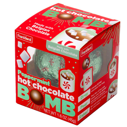 angle of red box with green and snowflake print foil wrapped hot chocolate bomb